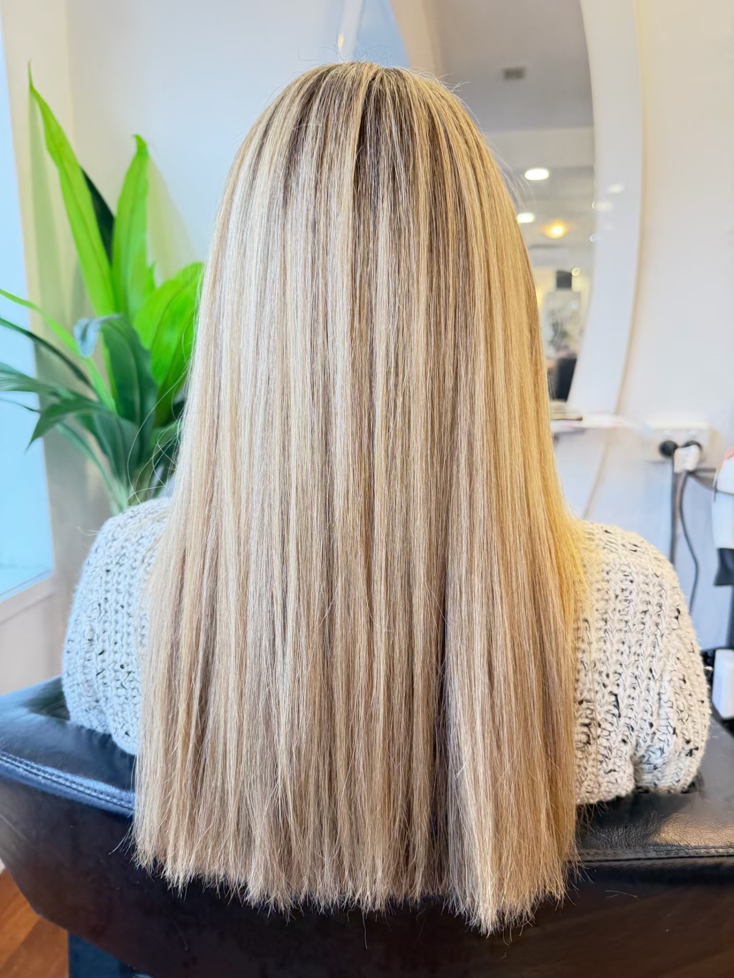 Long sleek blonde balayage with creamy tones